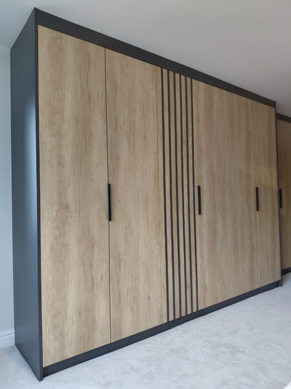 Contemporary wardrobe with wood effect doors, vertical slat detail and dark frame