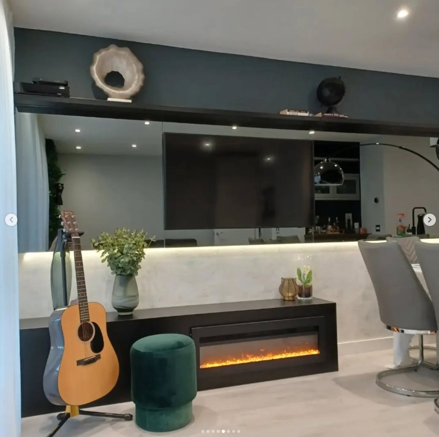 Open plan media wall with TV and integrated electric fireplace