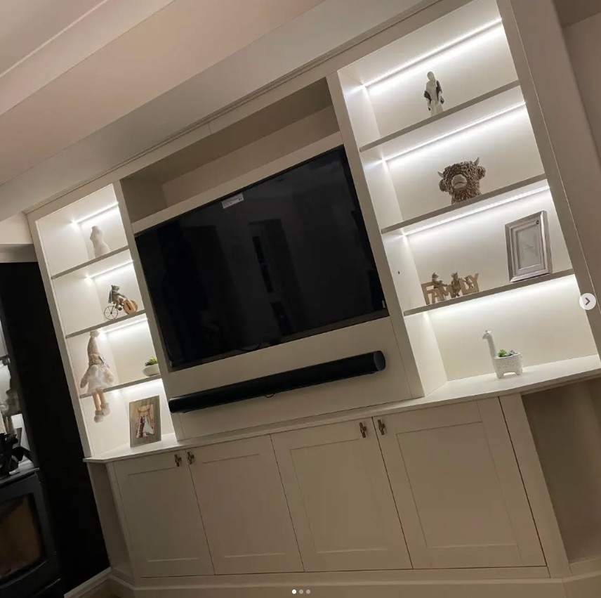 White media wall with illuminated display shelves